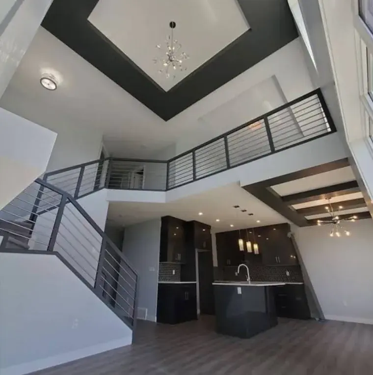 Vaulted open-concept great room with modern dark kitchen, freshly painted by Chamos Painting